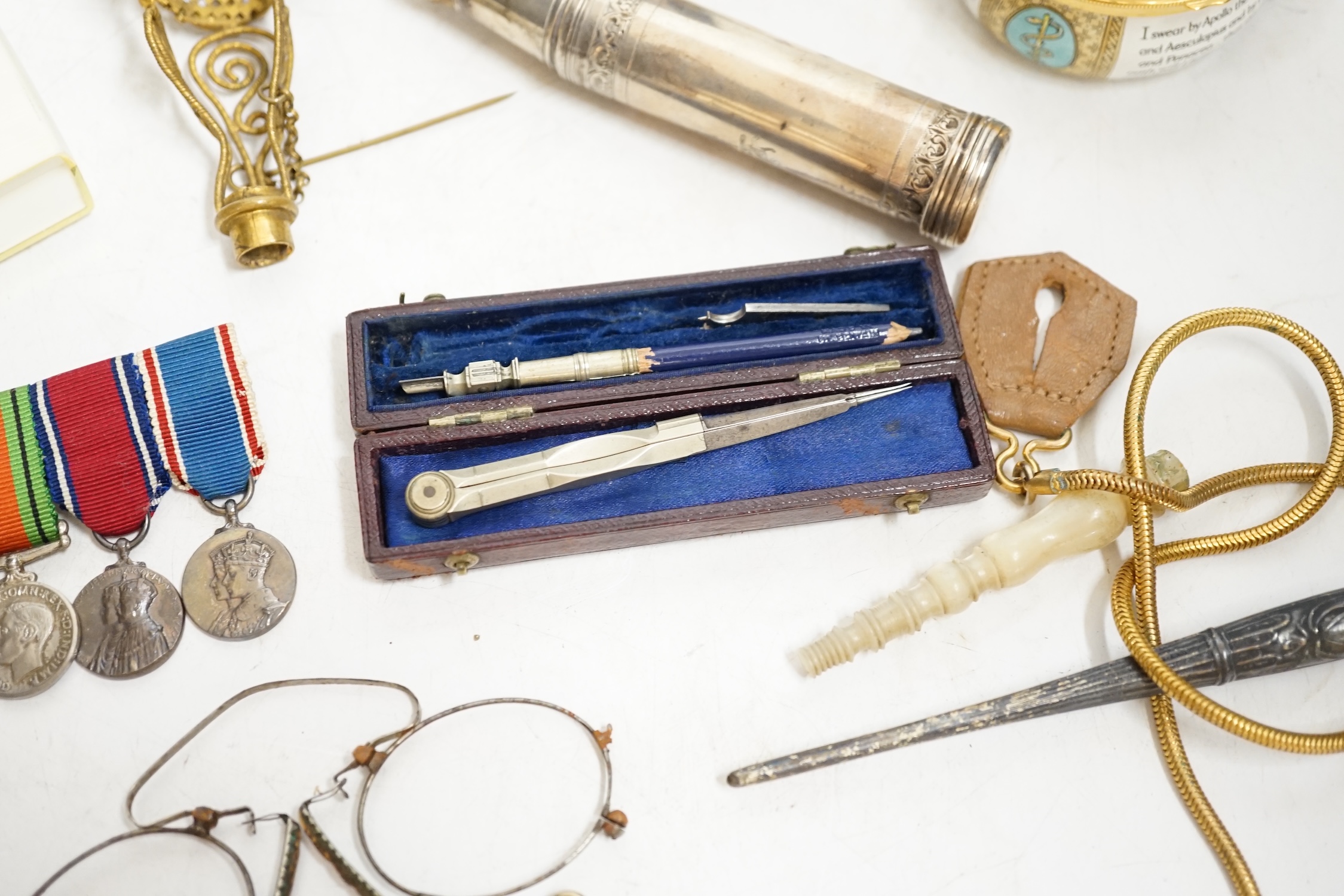 A group of mixed collectables including a gilt metal and turquoise posy holder, silver mounted shaving brush and miniature leather cased drawing set. Condition - varies